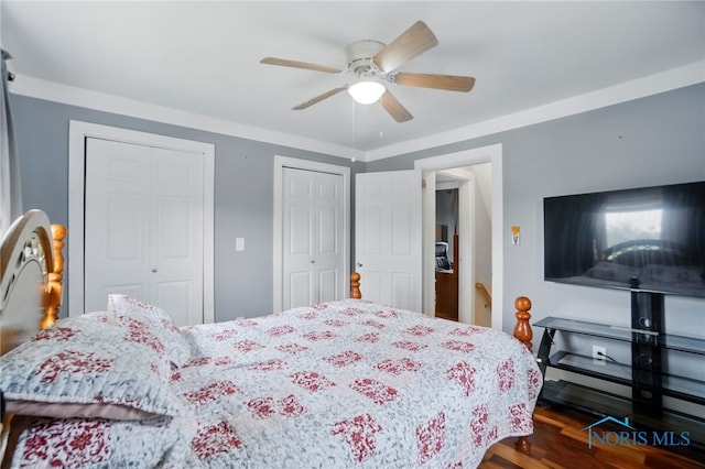 404 W Yates Ave, Findlay, OH 45840 - bedroom featuring two closets, dark wood-type flooring, and a ceiling fan