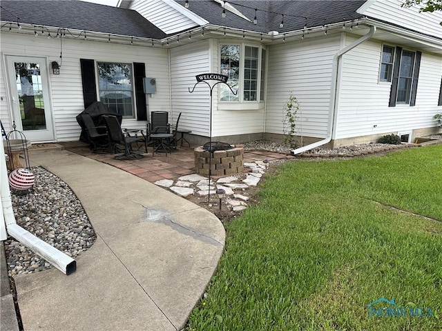 20515 Lockwood Rd, Defiance, OH 43512 - rear view of property featuring a yard, a patio, a fire pit, and roof with shingles