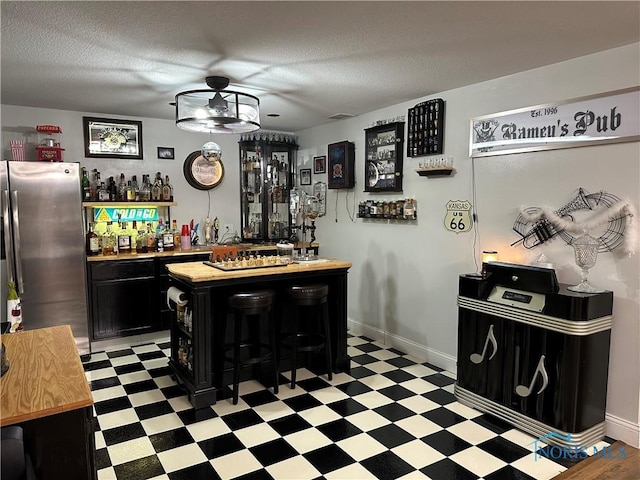 20515 Lockwood Rd, Defiance, OH 43512 - community bar area featuring stainless steel refrigerator with ice dispenser, light floors, a textured ceiling, and baseboards