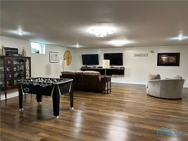 20515 Lockwood Rd, Defiance, OH 43512 - game room featuring dark wood-style floors, a textured ceiling, and baseboards