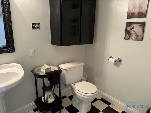 20515 Lockwood Rd, Defiance, OH 43512 - half bath featuring tile patterned floors, toilet, and baseboards