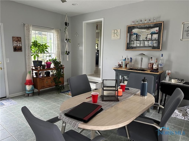 20515 Lockwood Rd, Defiance, OH 43512 - tiled dining space featuring a dry bar and baseboards