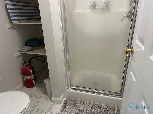 20515 Lockwood Rd, Defiance, OH 43512 - full bathroom featuring toilet, a shower stall, tile patterned floors, and baseboards