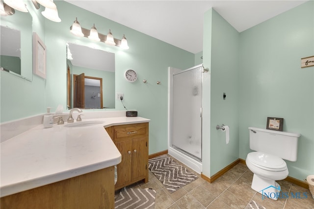 9389 County Road N2, Napoleon, OH 43535 - bathroom with toilet, vanity, a shower stall, baseboards, and tile patterned flooring