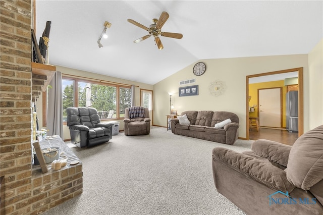 9389 County Road N2, Napoleon, OH 43535 - carpeted living area featuring vaulted ceiling, ceiling fan, and a fireplace