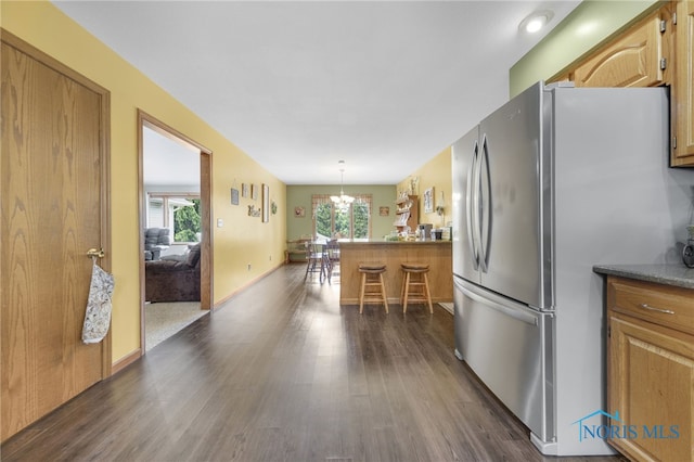 9389 County Road N2, Napoleon, OH 43535 - kitchen featuring freestanding refrigerator, plenty of natural light, dark wood-style floors, and a chandelier