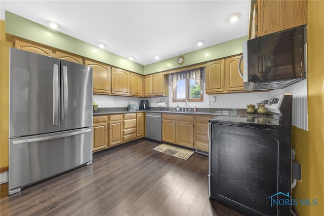 9389 County Road N2, Napoleon, OH 43535 - kitchen with stainless steel appliances, a sink, dark countertops, dark wood-style floors, and brown cabinets