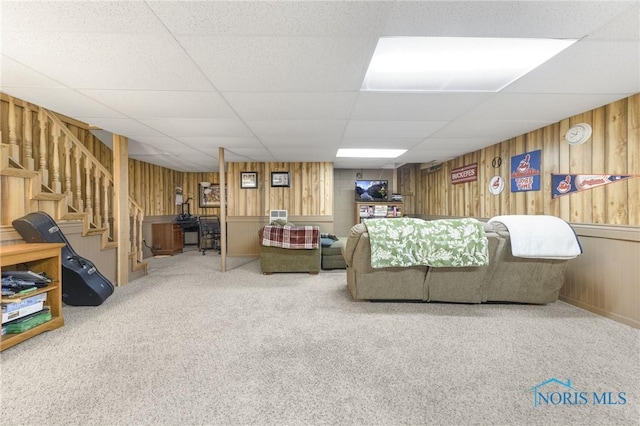 9389 County Road N2, Napoleon, OH 43535 - living room featuring wood walls, stairs, carpet floors, and a drop ceiling