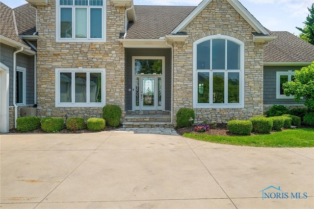 3051 Deep Water Ln, Maumee, OH 43537 - doorway to property featuring stone siding and a shingled roof