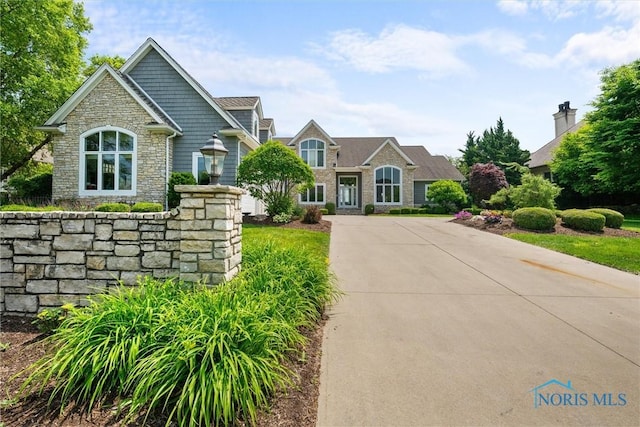 3051 Deep Water Ln, Maumee, OH 43537 - view of front of home featuring stone siding and driveway