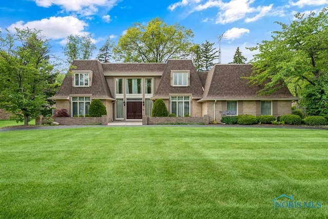 4123 Shamley Green Dr, Toledo, OH 43623 - view of front facade with a shingled roof, a front yard, mansard roof, and brick siding