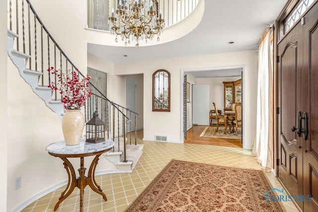 4123 Shamley Green Dr, Toledo, OH 43623 - entrance foyer featuring stairs, a chandelier, a towering ceiling, and baseboards