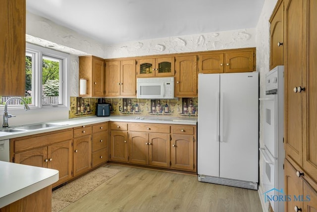 4123 Shamley Green Dr, Toledo, OH 43623 - kitchen featuring white appliances, a sink, brown cabinets, and light wood-style floors