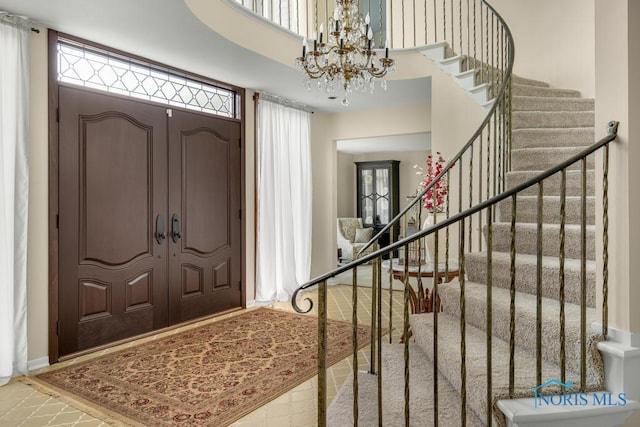 4123 Shamley Green Dr, Toledo, OH 43623 - foyer with a chandelier, stairway, a high ceiling, and baseboards