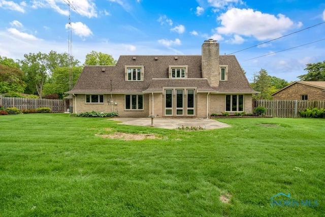 4123 Shamley Green Dr, Toledo, OH 43623 - back of property featuring a patio, a shingled roof, a chimney, and brick siding