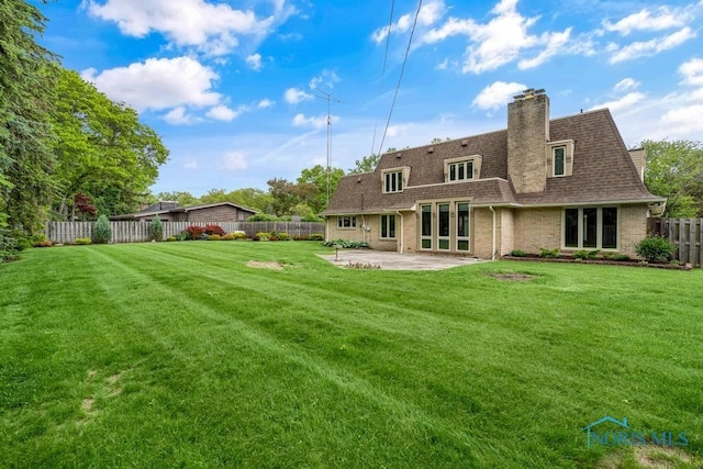 4123 Shamley Green Dr, Toledo, OH 43623 - back of house with a patio area, a shingled roof, brick siding, and a chimney