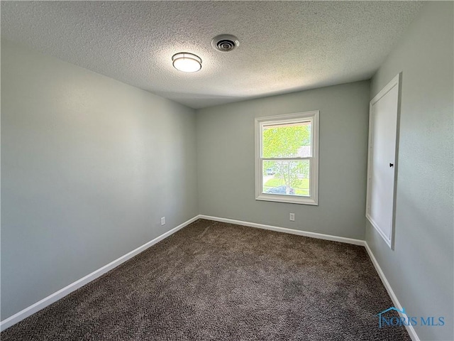2655 101st St, Toledo, OH 43611 - empty room with dark carpet, baseboards, and a textured ceiling