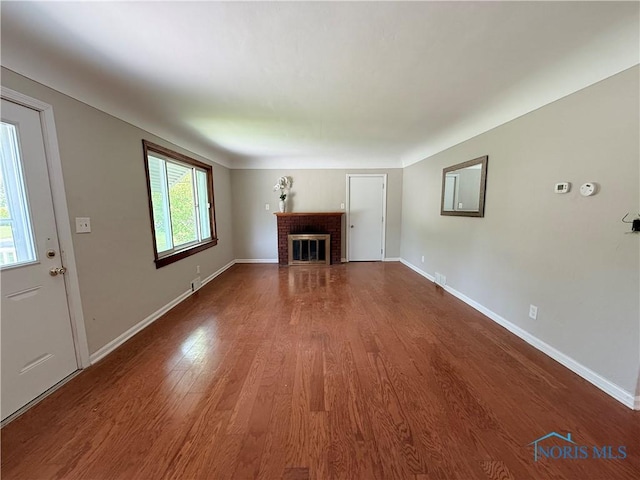 1641 Morrison Rd, Fremont, OH 43420 - unfurnished living room featuring wood finished floors, a fireplace, and baseboards