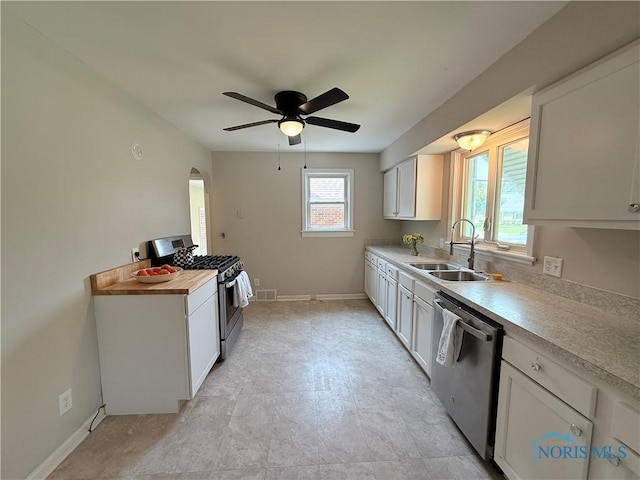 1641 Morrison Rd, Fremont, OH 43420 - kitchen with appliances with stainless steel finishes, a sink, ceiling fan, light countertops, and baseboards