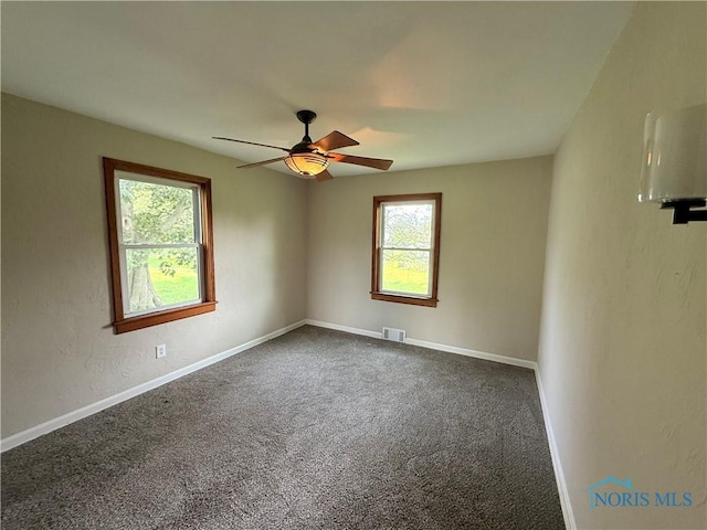 1641 Morrison Rd, Fremont, OH 43420 - unfurnished room featuring a ceiling fan, dark carpet, and baseboards