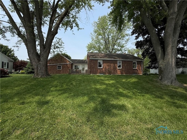 1641 Morrison Rd, Fremont, OH 43420 - back of house featuring a lawn and brick siding