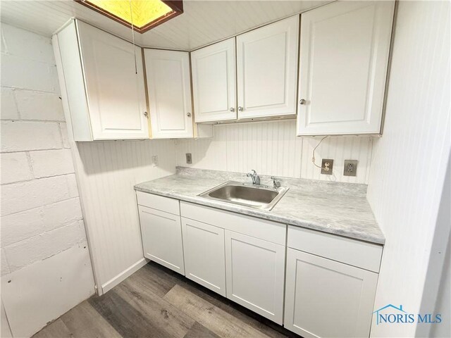 1641 Morrison Rd, Fremont, OH 43420 - kitchen featuring a sink, dark wood finished floors, light countertops, and white cabinetry