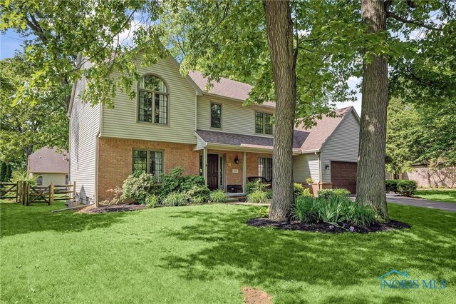 8225 Hidden Forest Dr, Holland, OH 43528 - view of front of property featuring a garage and brick siding