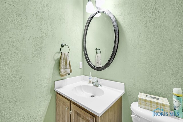 8225 Hidden Forest Dr, Holland, OH 43528 - bathroom featuring vanity, a textured wall, and toilet