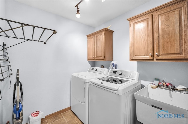 8225 Hidden Forest Dr, Holland, OH 43528 - washroom featuring cabinet space, separate washer and dryer, and baseboards