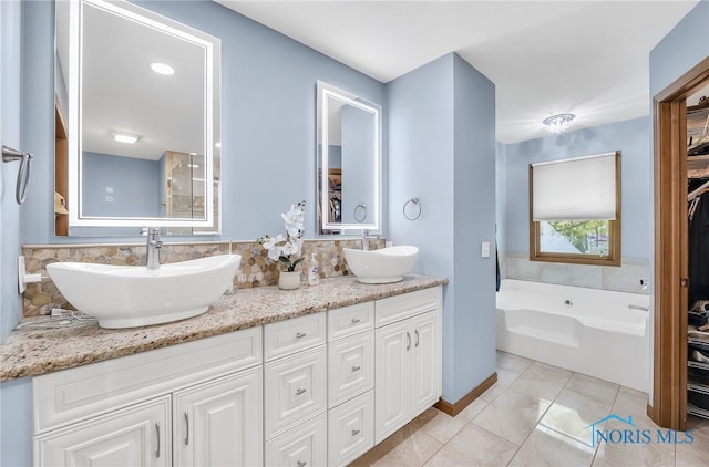 8225 Hidden Forest Dr, Holland, OH 43528 - full bath featuring double vanity, a garden tub, tile patterned flooring, a closet, and tasteful backsplash