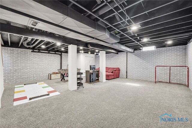 8225 Hidden Forest Dr, Holland, OH 43528 - finished basement with brick wall and carpet