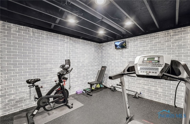 8225 Hidden Forest Dr, Holland, OH 43528 - workout area featuring brick wall