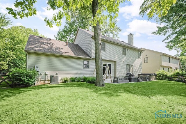 8225 Hidden Forest Dr, Holland, OH 43528 - back of house with a lawn, a patio area, a chimney, and central AC