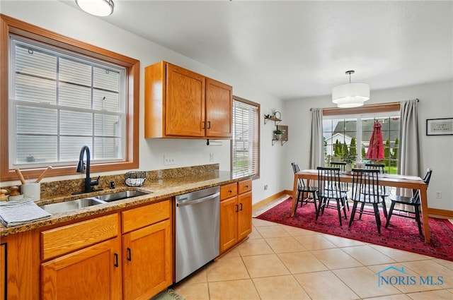 28178 Schriber St, Walbridge, OH 43465 - kitchen featuring stainless steel dishwasher, a sink, light tile patterned floors, stone counters, and brown cabinets