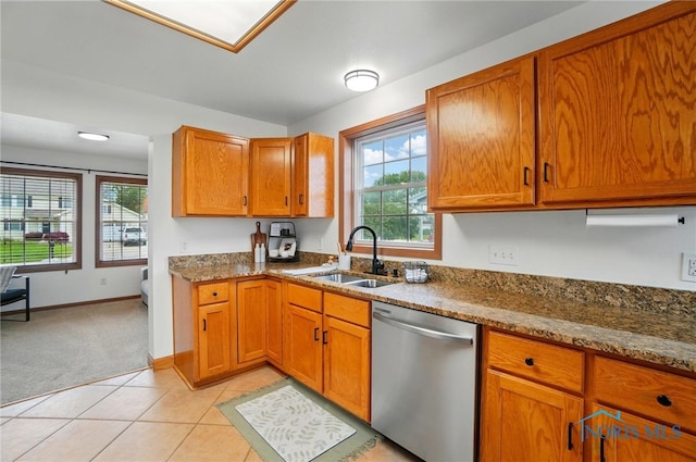 28178 Schriber St, Walbridge, OH 43465 - kitchen with dishwasher, a sink, brown cabinets, and dark stone countertops