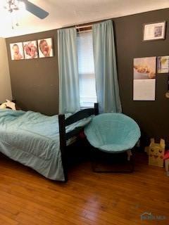 129 Central Ave, North Baltimore, OH 45872 - bedroom with wood finished floors and ceiling fan