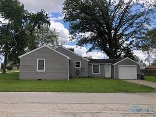 129 Central Ave, North Baltimore, OH 45872 - ranch-style house featuring a garage, driveway, and a front lawn