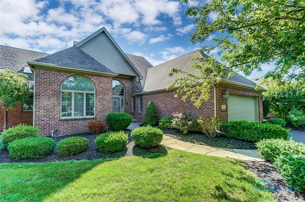 5 Callander Ct, Perrysburg, OH 43551 - view of front of home with brick siding, an attached garage, roof with shingles, and a front lawn