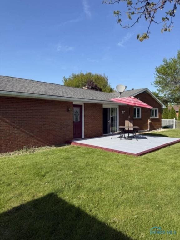 1133 Inverness Dr, Findlay, OH 45840 - back of property with brick siding, a yard, and a patio