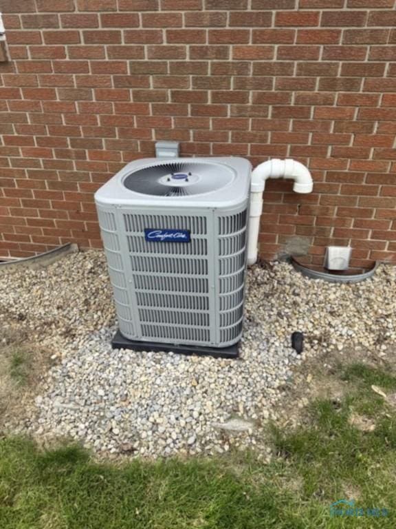 1133 Inverness Dr, Findlay, OH 45840 - exterior view of central air condition unit and brick siding