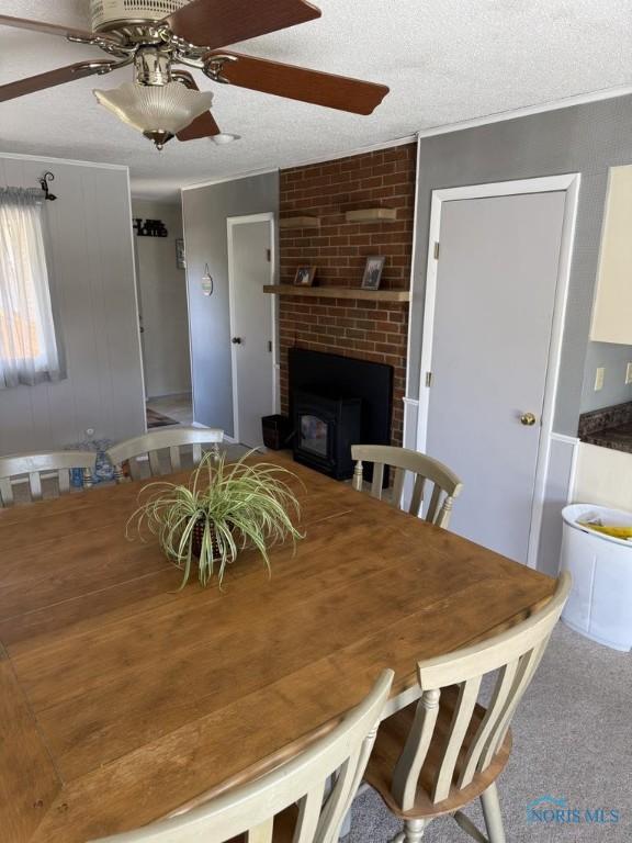 1133 Inverness Dr, Findlay, OH 45840 - dining room with a ceiling fan, ornamental molding, a textured ceiling, and a fireplace