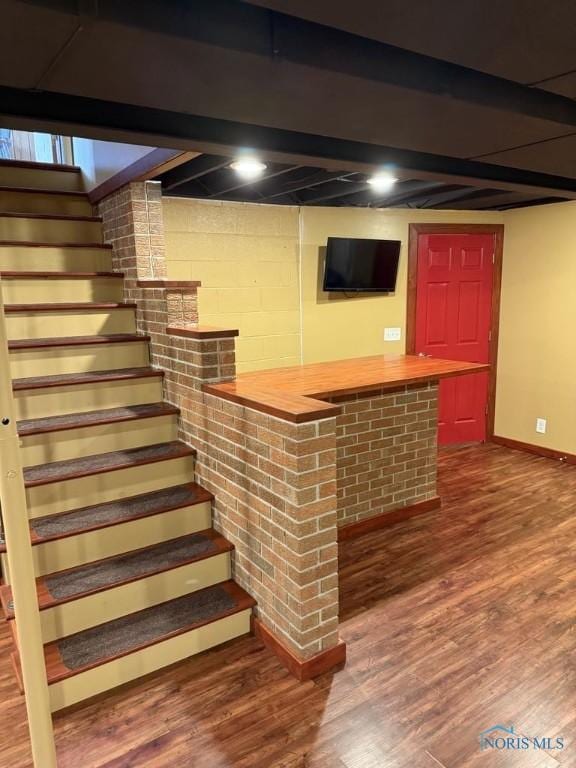 1133 Inverness Dr, Findlay, OH 45840 - indoor dry bar featuring stairway, baseboards, and wood finished floors