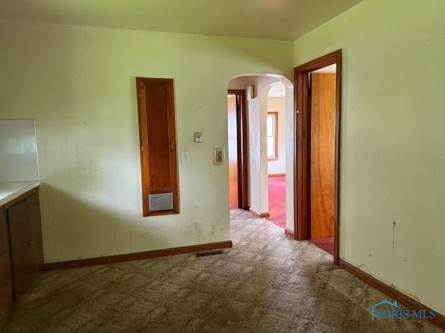 600 Tiedeman Ave, Defiance, OH 43512 - hall featuring arched walkways, carpet, and baseboards