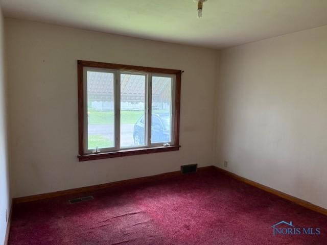 600 Tiedeman Ave, Defiance, OH 43512 - empty room featuring dark colored carpet and baseboards