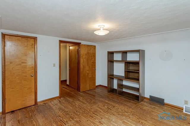 16470 County Road P, Napoleon, OH 43545 - unfurnished bedroom with wood finished floors, baseboards, and a closet