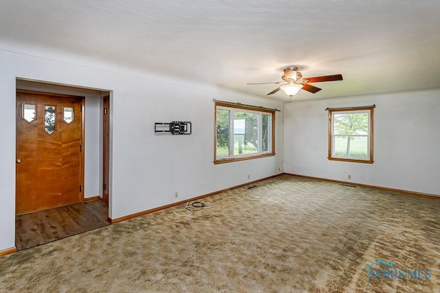 16470 County Road P, Napoleon, OH 43545 - spare room featuring plenty of natural light, ceiling fan, baseboards, and carpet