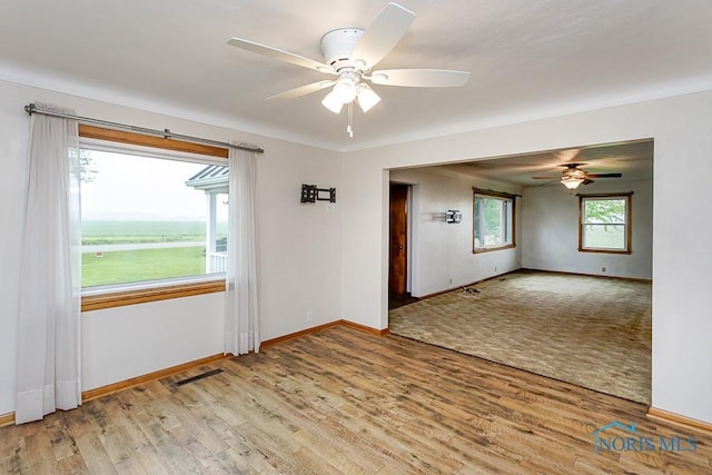 16470 County Road P, Napoleon, OH 43545 - unfurnished room with a ceiling fan, wood finished floors, and baseboards