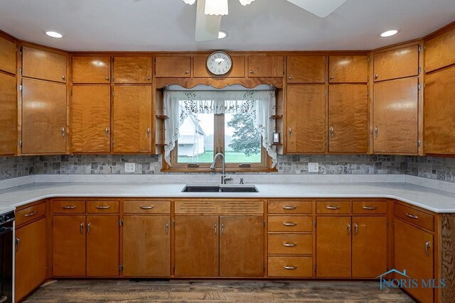 16470 County Road P, Napoleon, OH 43545 - kitchen with a sink, brown cabinets, dark wood finished floors, light countertops, and recessed lighting
