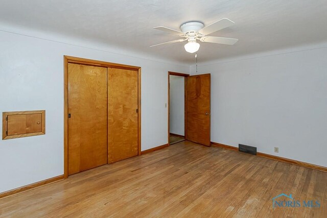 16470 County Road P, Napoleon, OH 43545 - unfurnished bedroom with light wood-style floors, baseboards, a closet, and a ceiling fan