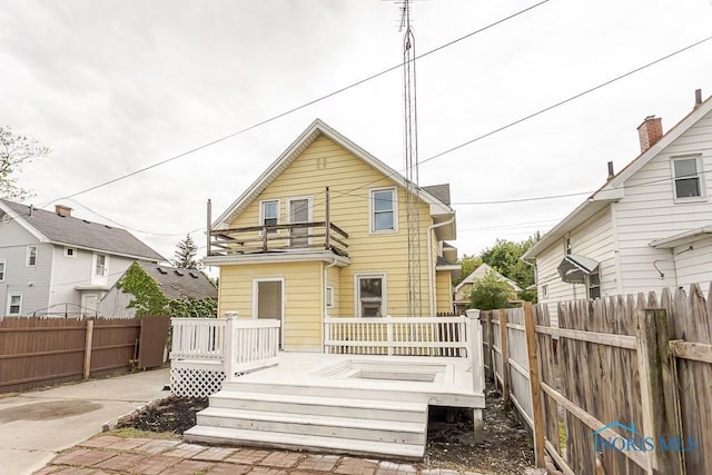 1385 Berdan Ave, Toledo, OH 43612 - back of property with a balcony, a fenced backyard, and a wooden deck